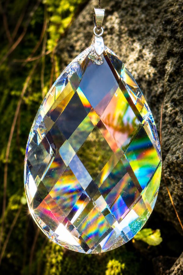 Hanging faceted teardrop crystal prism with rainbows