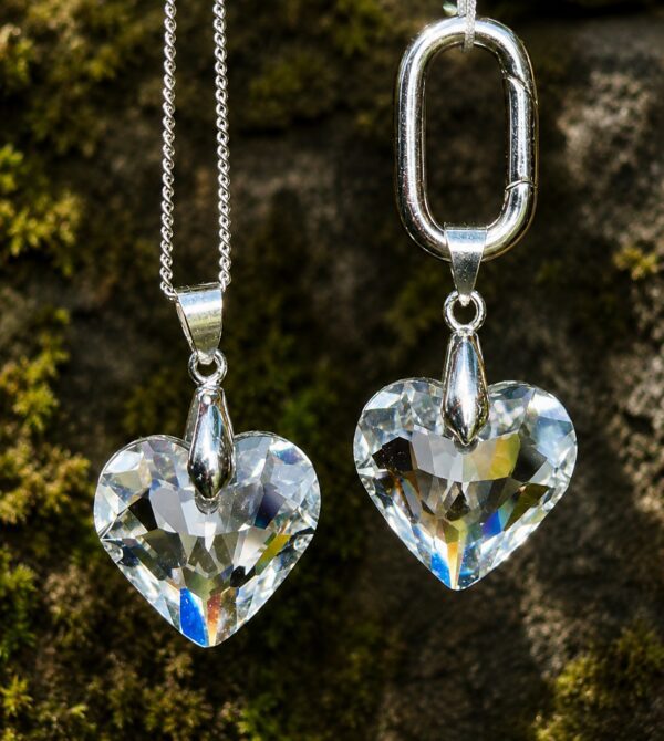 Two heart-shaped crystal pendants on chains