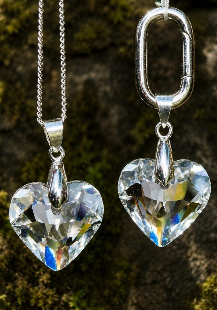 Two heart-shaped crystal pendants on chains